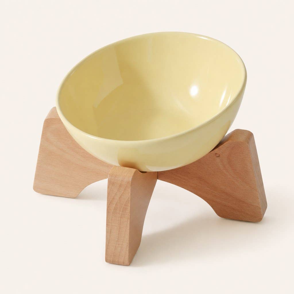 Elevated ceramic cat bowl with wooden stand in yellow